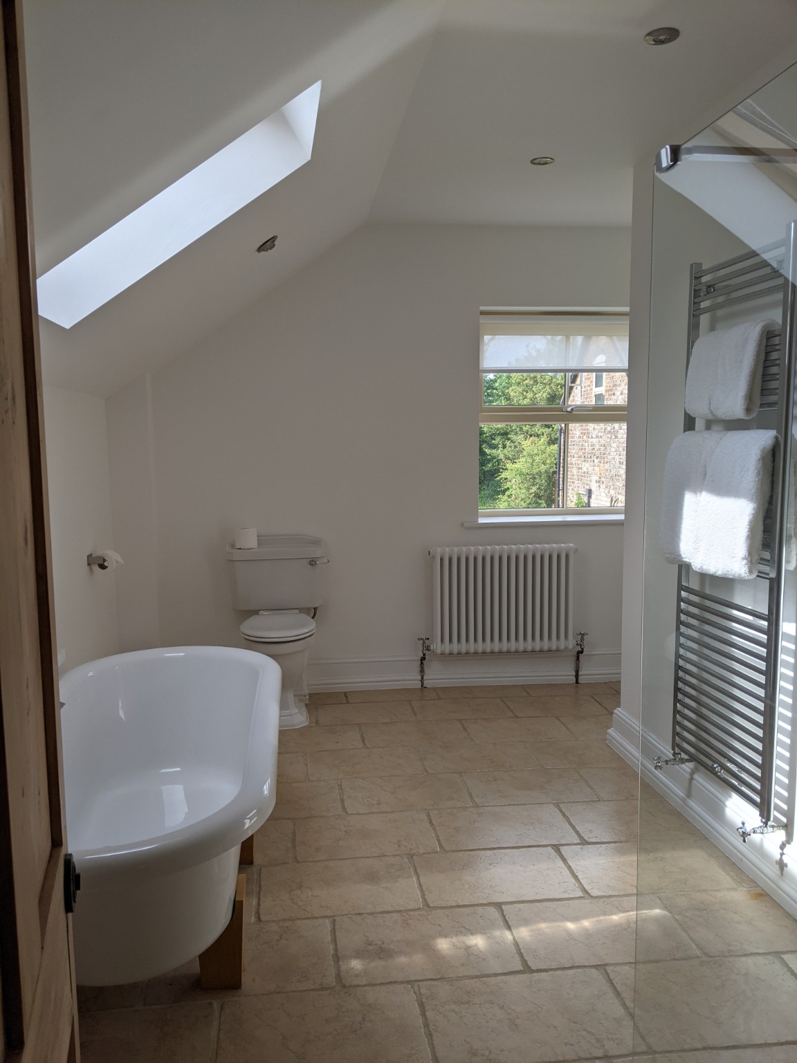 Pratchett: the bathroom with roll-top bath under the skylight.