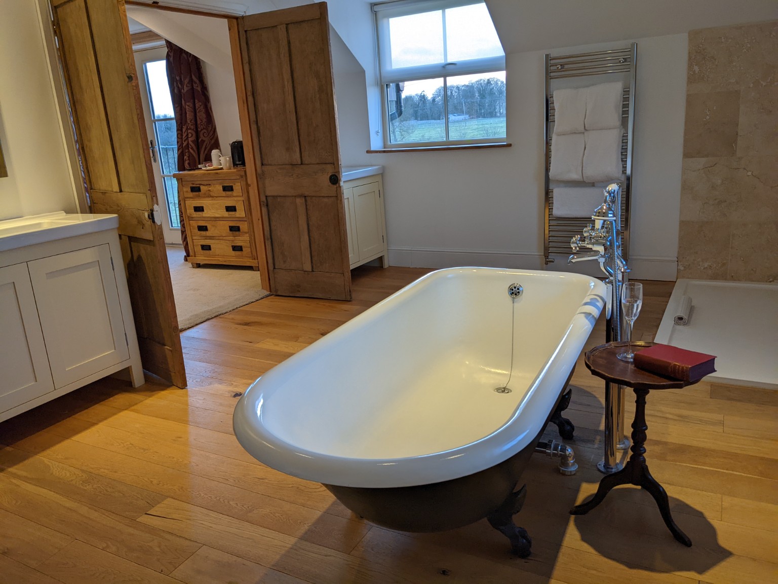 Robin: the cast-iron freestanding bath on the wooden bathroom floor.