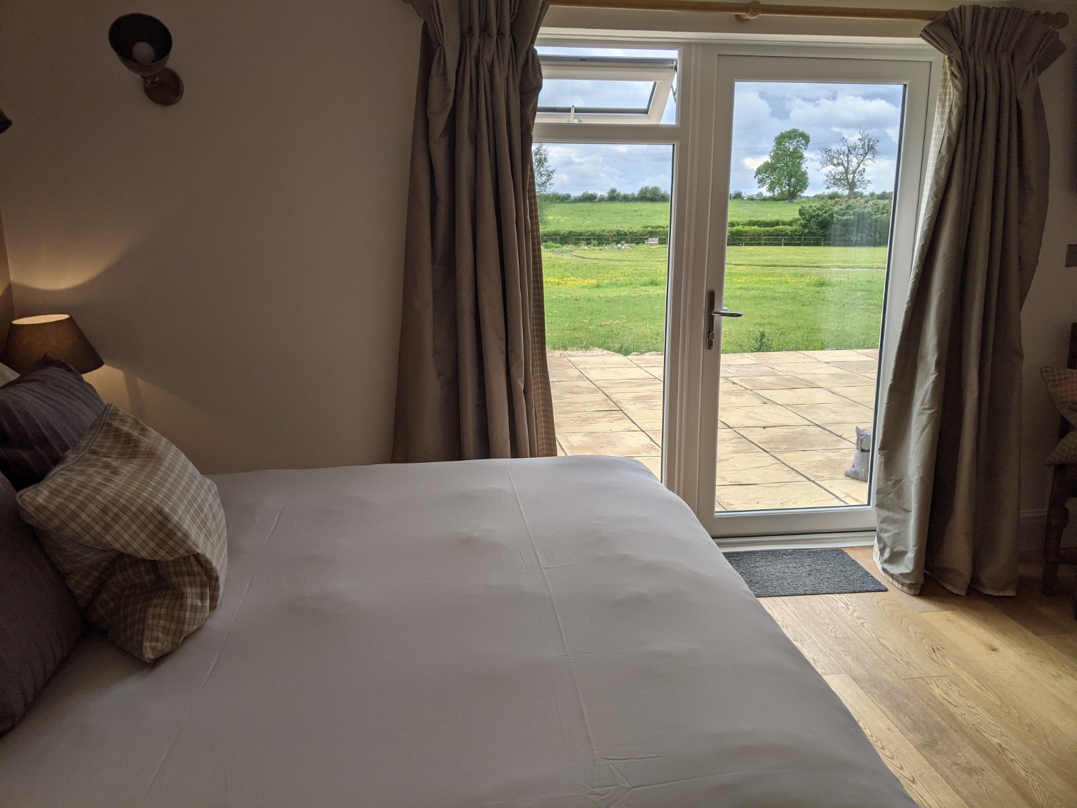 Cobstone: the bed, with the field view through the patio doors.