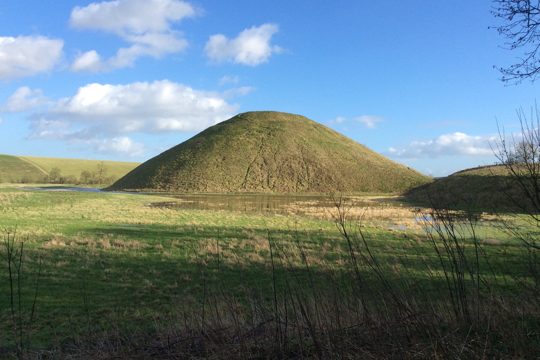 Neolithic Silbury Hill rising from the Wiltshire fields.